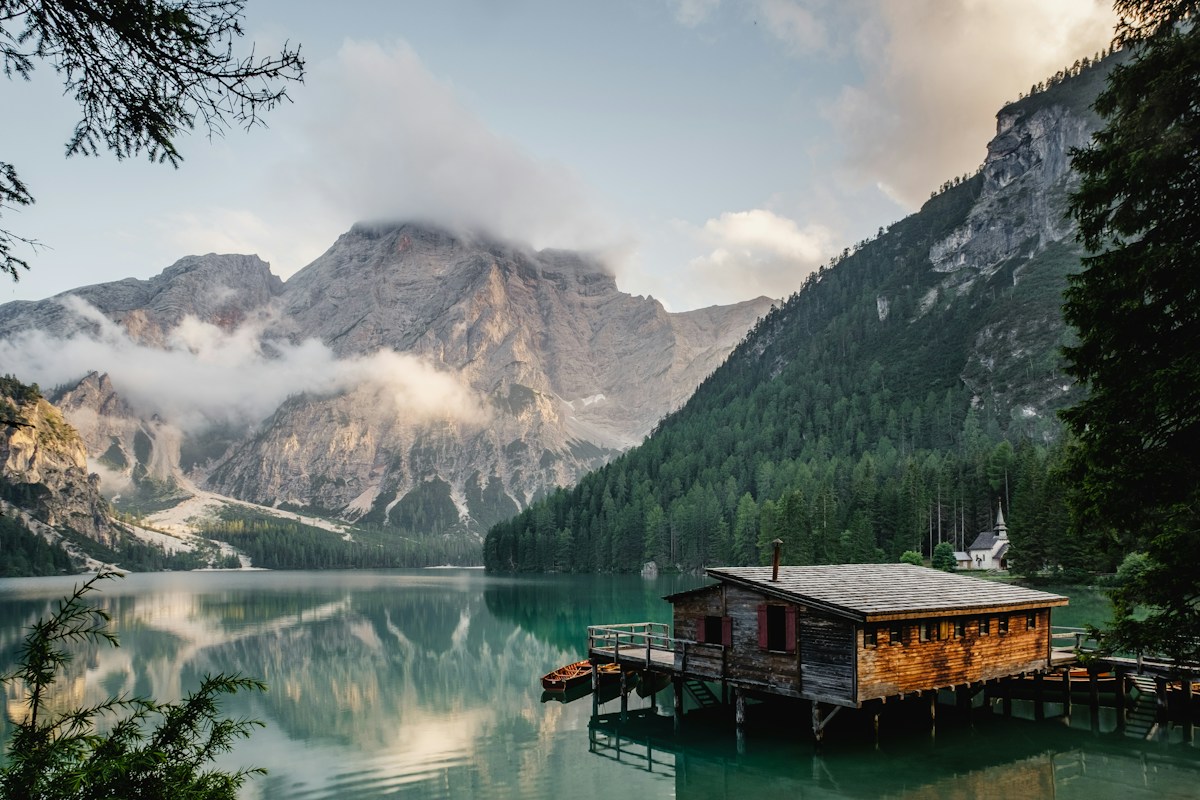 An isolated cabin beside a mountain lake